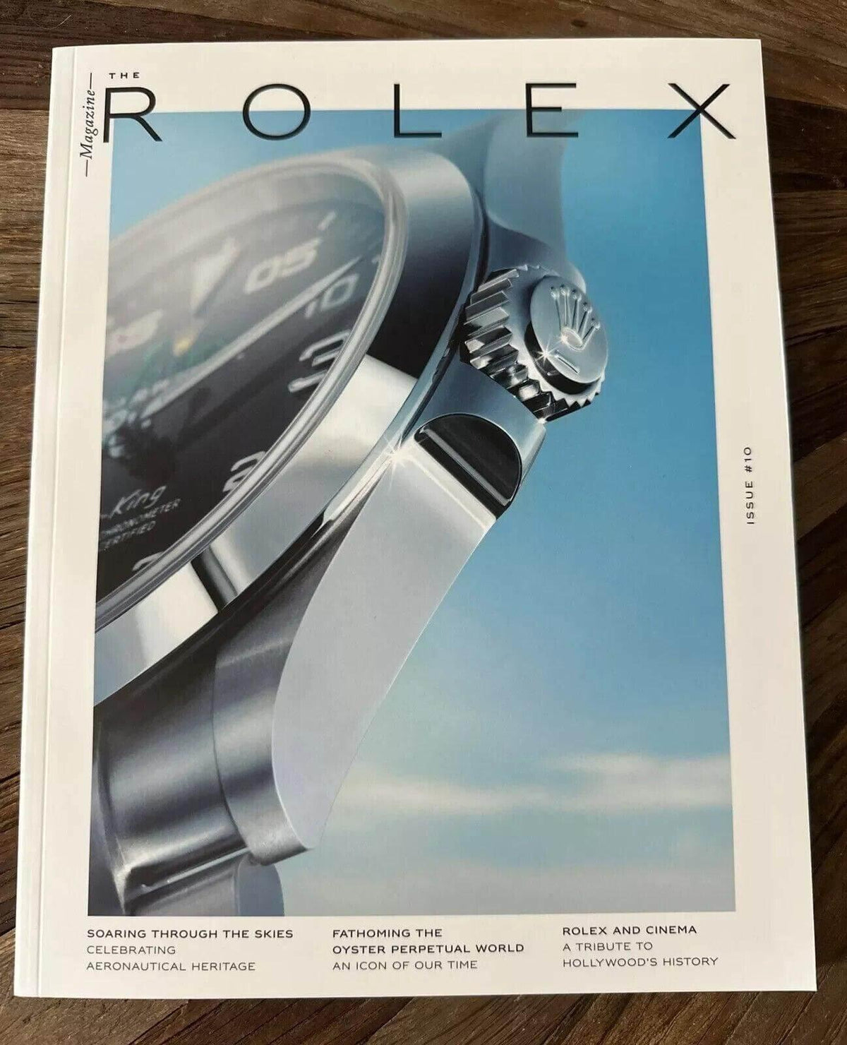 The Rolex Magazine Issue #10 cover featuring a close-up of a luxury watch against a sky backdrop, highlighting aviation heritage and cinematic tribute.