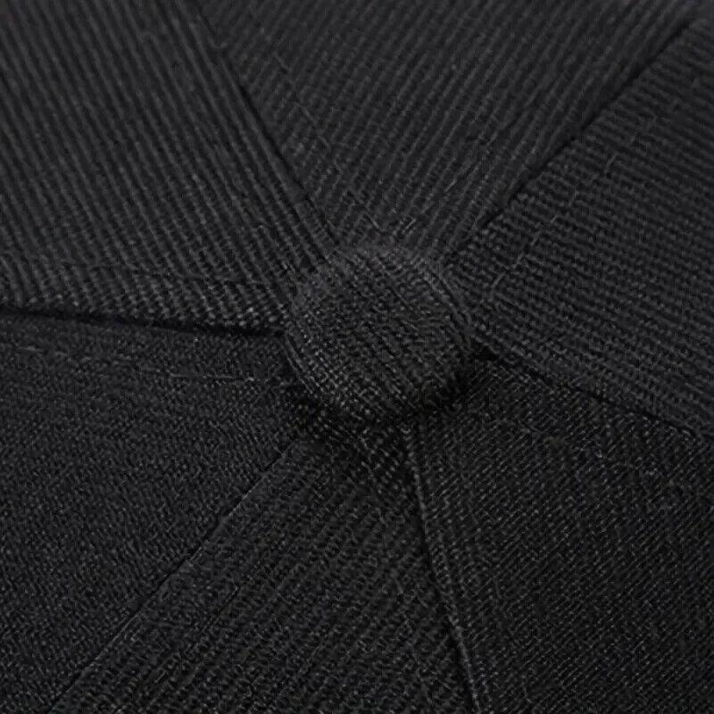 Black textured fabric with button detail, suitable for workwear or durable apparel