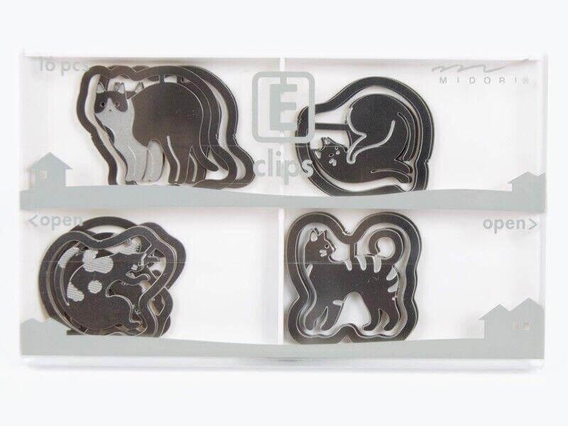Assorted steel E-clips shaped like cats for office paper organization, displayed in a tray
