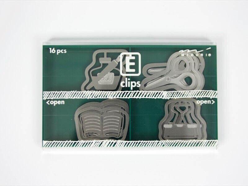 Set of 16 assorted metal paper clips in unique office shapes in a clear green box.