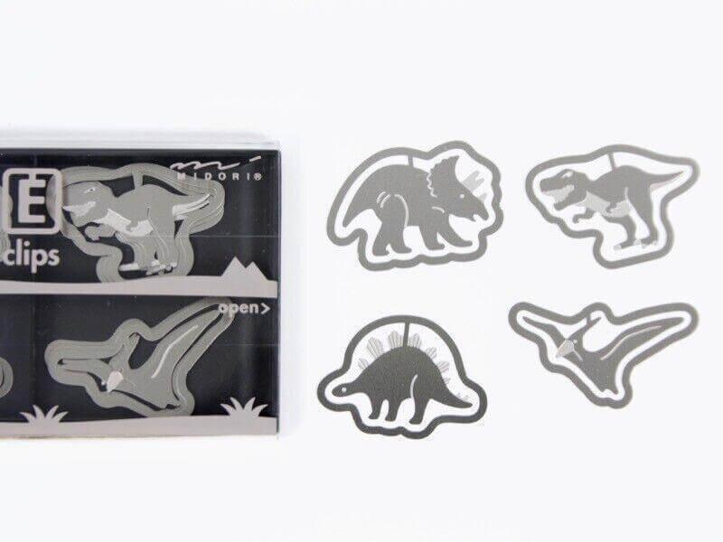 Steel dinosaur-shaped paper clips for documents, assorted metal office clips on white background