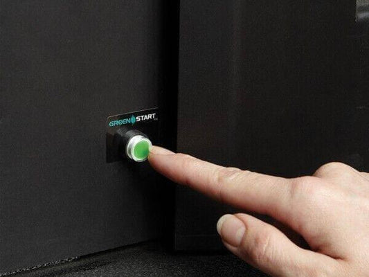 Finger pressing green start button on black device for office equipment