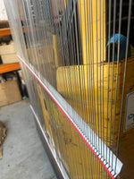 Forklift safety curtain with red trim in warehouse, protecting equipment and workers