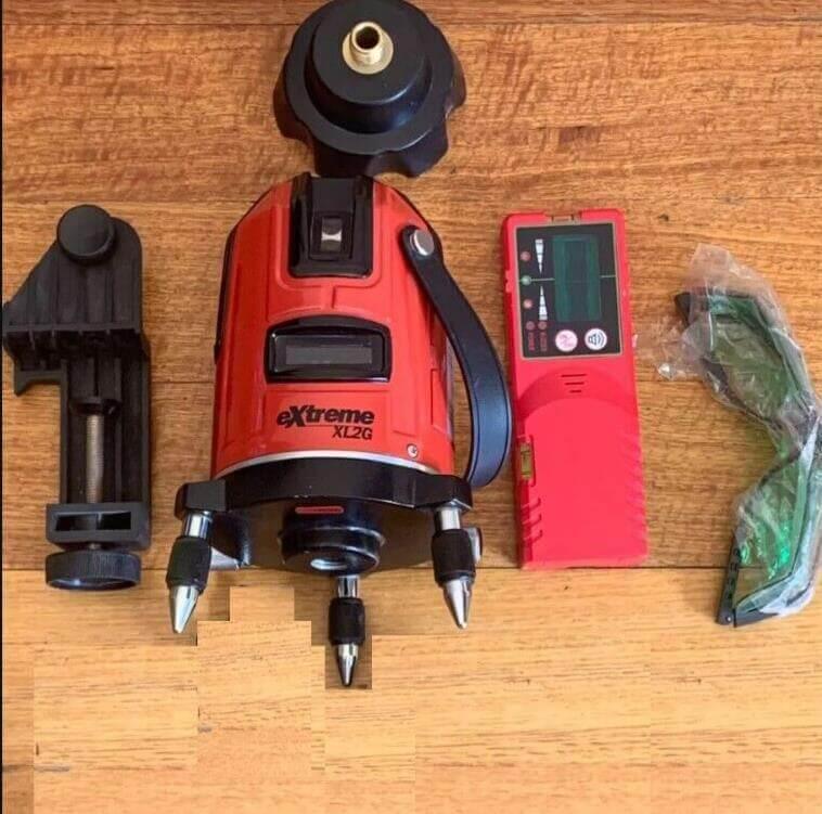 Red eXtreme XL2G laser level with accessories on wooden surface