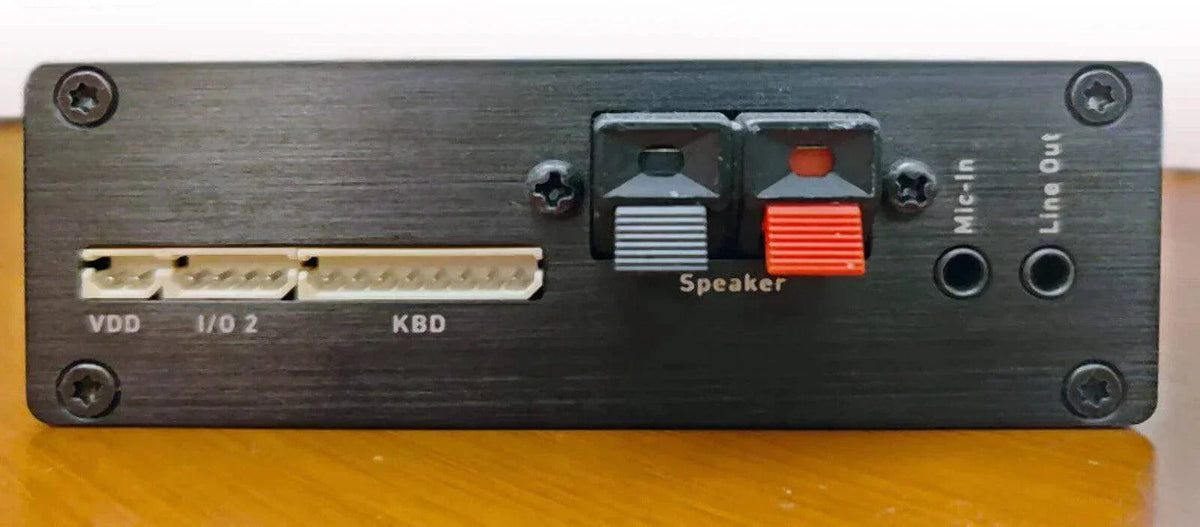 Black audio interface with speaker, mic-in, line-out ports and labeled connectors for office phones systems