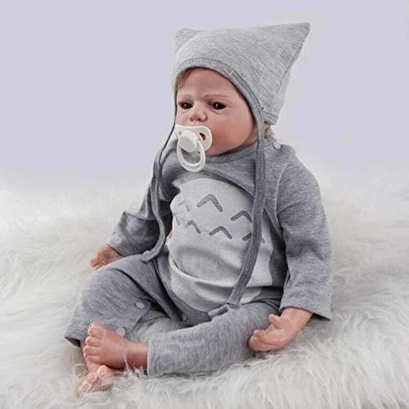 Realistic baby doll in gray Totoro outfit with pacifier, soft fur background