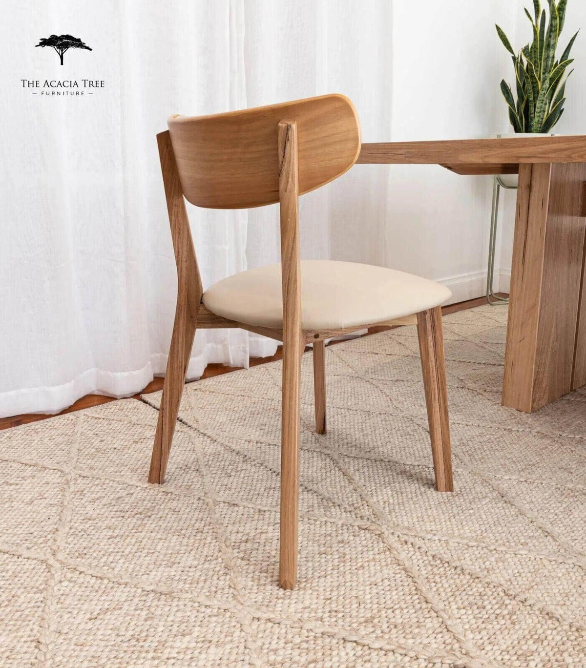 Modern wooden dining chair with cream cushion, sleek design, natural wood finish, perfect for contemporary home or office spaces.