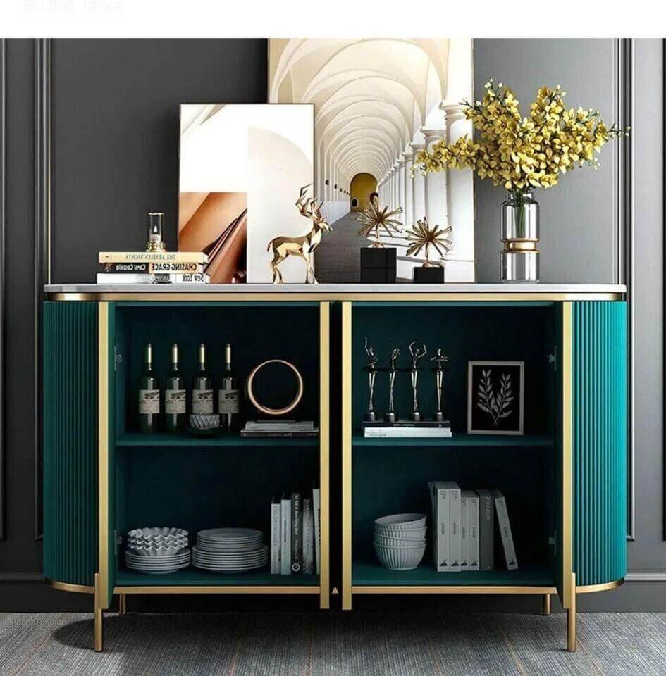 Modern teal sideboard with gold trim, open shelving displaying wine, books, and decor