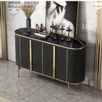 Modern black marble-top sideboard with gold accents, ribbed panels, and sleek legs for luxury entryway or living room decor