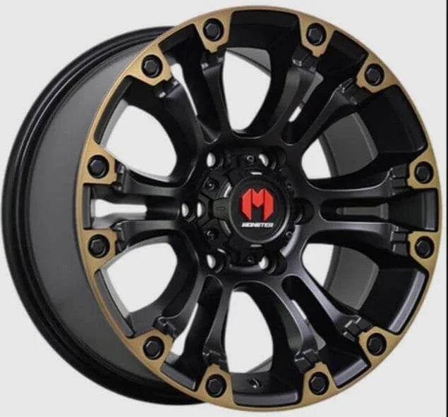 Black and gold Monstertire off-road wheel rim with bold spoke design for trucks and SUVs