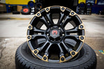 Black and gold Monster wheel rim on tire, rugged off-road design