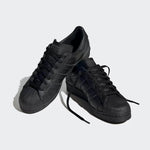 Black Adidas Superstar sneakers with classic shell toe design and three stripes, all-black casual footwear