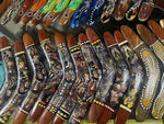 Hand-painted wooden boomerangs with Aboriginal dot art designs, vibrant colors, and intricate patterns.