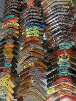 Colorful hand-painted boomerangs with Aboriginal art designs displayed in rows