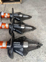 Three Olmatro hydraulic rescue cutters on concrete floor, heavy-duty emergency tools for vehicle extrication