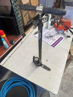 Nomato floor pump with pressure gauge on workshop table, ideal for tire inflation tasks