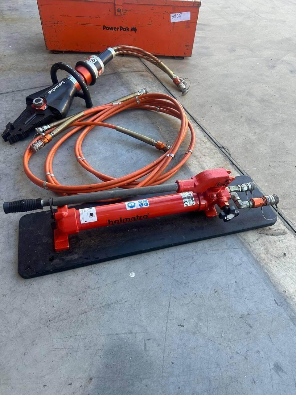 Holmatro hydraulic rescue tools with orange hoses and Power Pak case for heavy-duty extraction