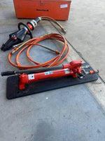 Holmatro hydraulic rescue tools with orange hoses and Power Pak case for heavy-duty extraction
