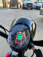 Electric Harley e-bike dashboard with full battery indicator, parked in lot