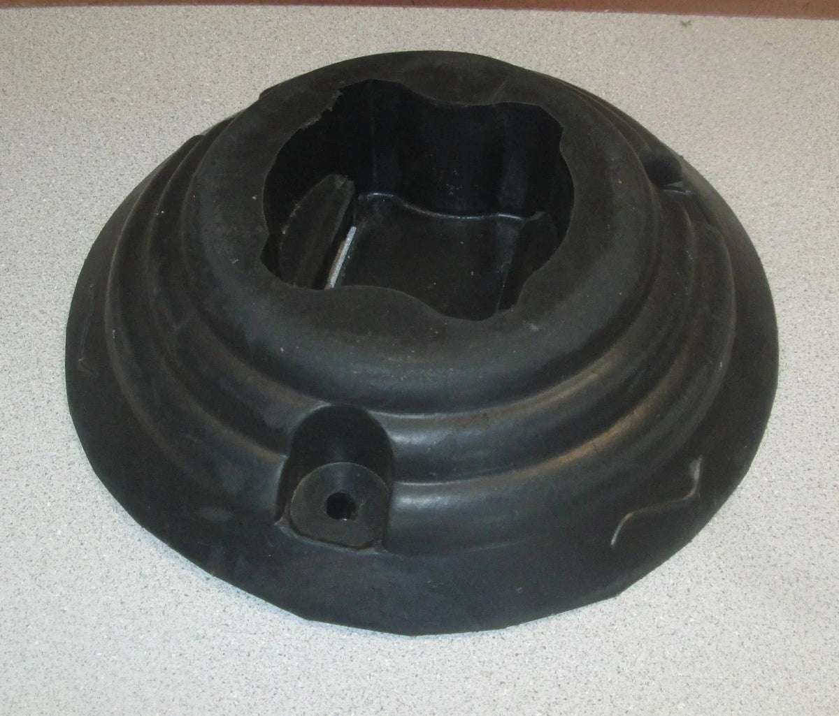 Black rubber tractor part with central opening and mounting holes, compatible with AGCO and EATON equipment