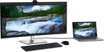 Dell monitor and laptop setup with keyboard, mouse, and scenic waterfall display