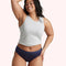 Woman wearing navy blue underwear and gray tank top, smiling with hand on hip