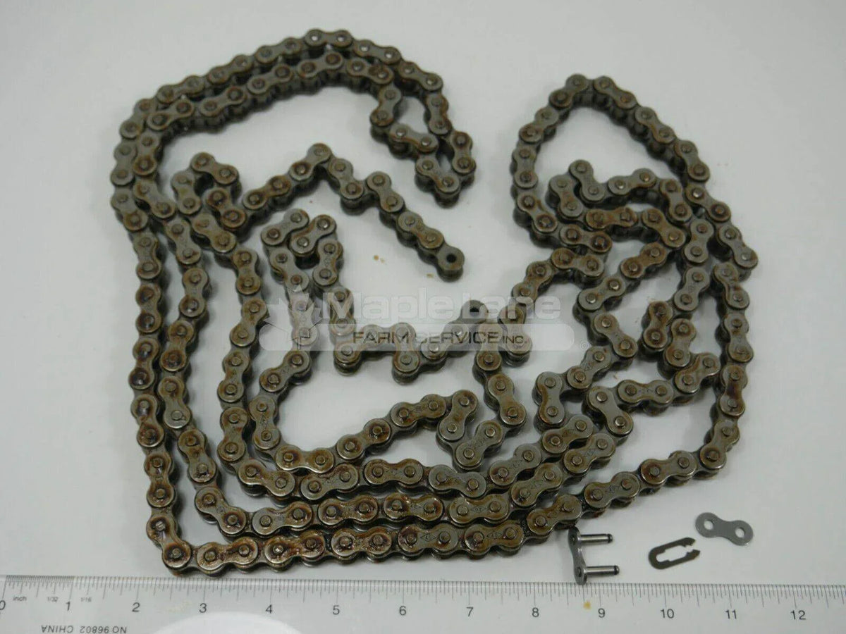 Steel diamond chain with connector links for tractor, displayed on white background with ruler