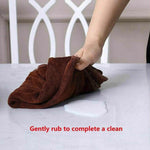 Wiping a spill from a clear PVC table cover with a soft cloth