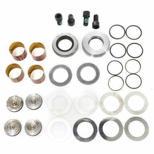 King pin bearing kit for trucks with bushings, seals, washers, bolts, and O-rings laid out on white background