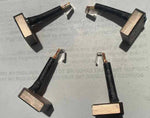 Set of four replacement carbon brushes for tractor or automotive alternators on a plain background.