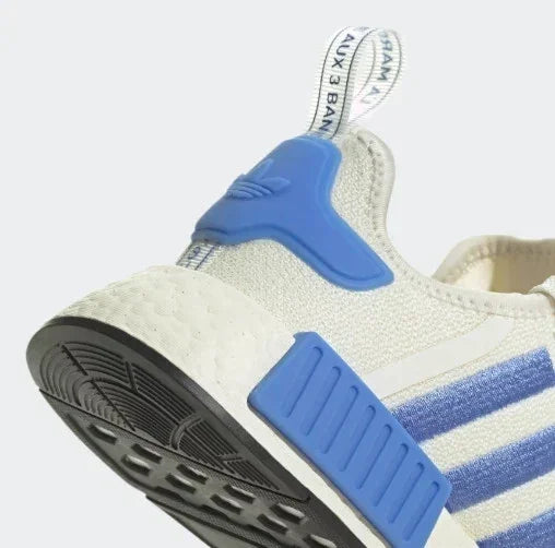 Blue and white Adidas NMD sneaker with striped side panels and textured sole