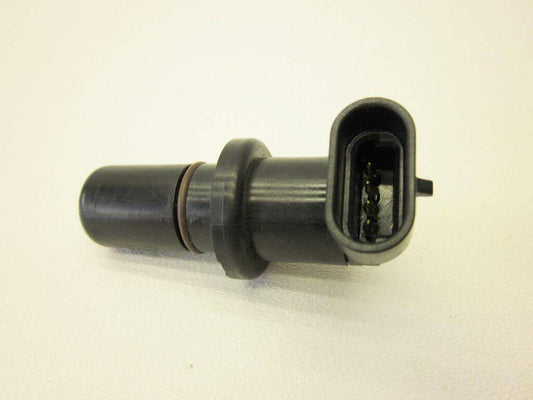 Black automotive sensor part with connector pins on a white background