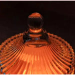 Amber glass candy dish with scalloped edge and decorative knob lid