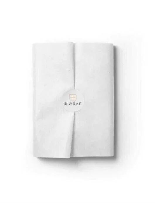 Stack of white acid-free tissue paper sheets neatly folded for gift wrapping