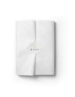 Stack of white acid-free tissue paper sheets neatly folded for gift wrapping