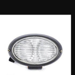 Oval tractor worklight with clear lens and black housing, spare part for agricultural vehicles
