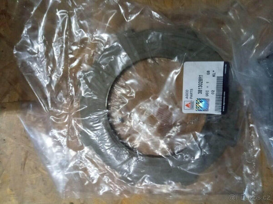 Metal tractor plate part labeled 3813028M1 in clear plastic packaging on wooden surface