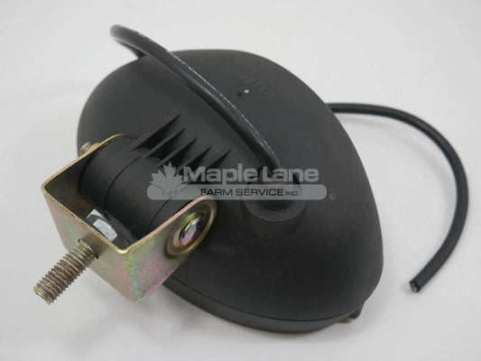 Black tractor work lamp with mounting bracket and attached wiring on white background