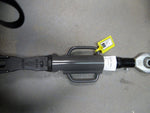 Metal tractor hanger part with handles and label on a concrete surface