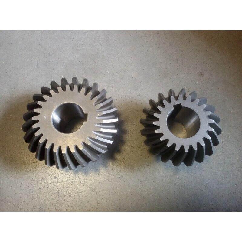 Bevel gear set for tractor or machinery replacement parts on a grey background
