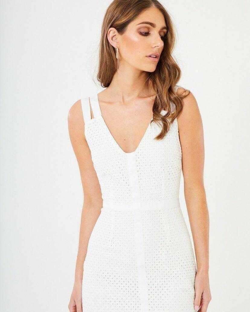 Woman wearing elegant white lace midi dress with V-neck, sleeveless design, formal attire