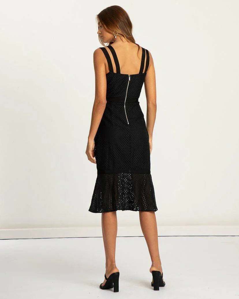 Woman wearing black lace midi dress with double straps and flared hem, viewed from back
