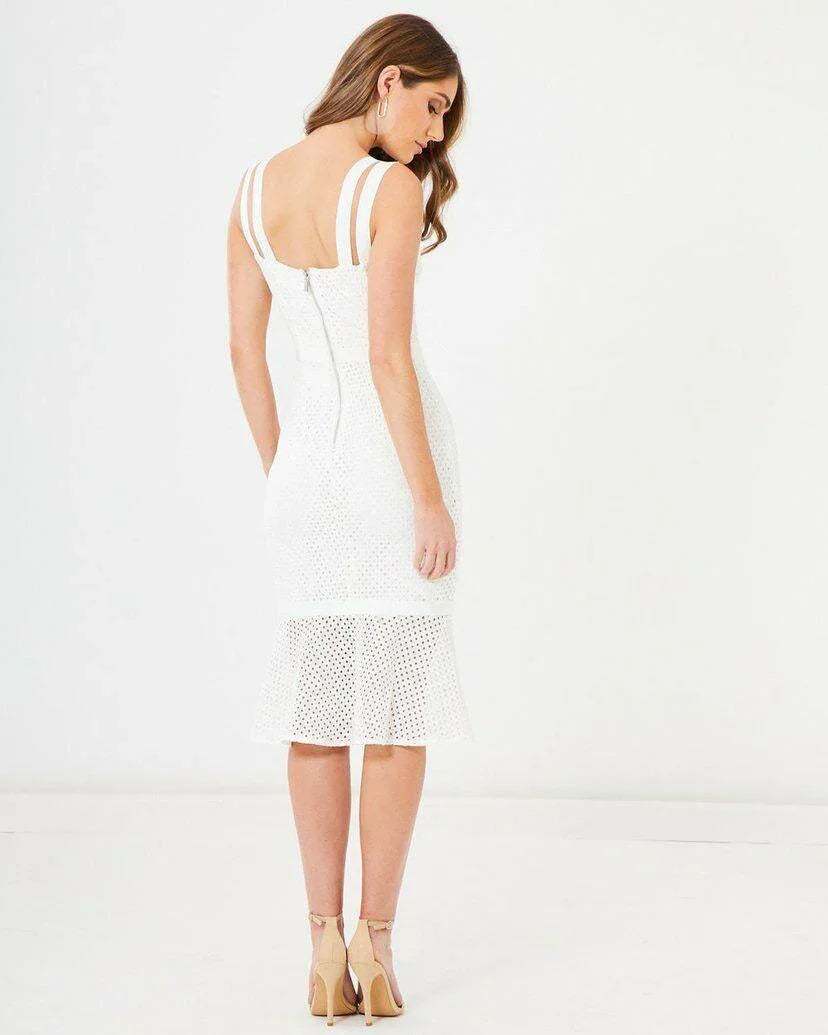 Woman wearing a white lace midi dress with double shoulder straps and flared hem, back view