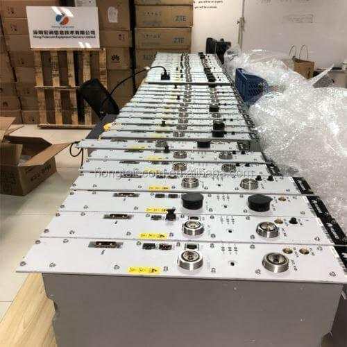 Multiple telecom radio transceiver units on a table in a warehouse setting