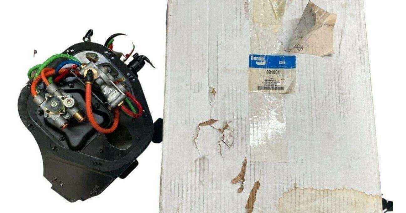 Bendix truck brake module with colorful wires next to original white packaging box