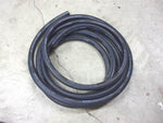 Coiled black Fleetrite heater coolant hose for trucks on concrete floor