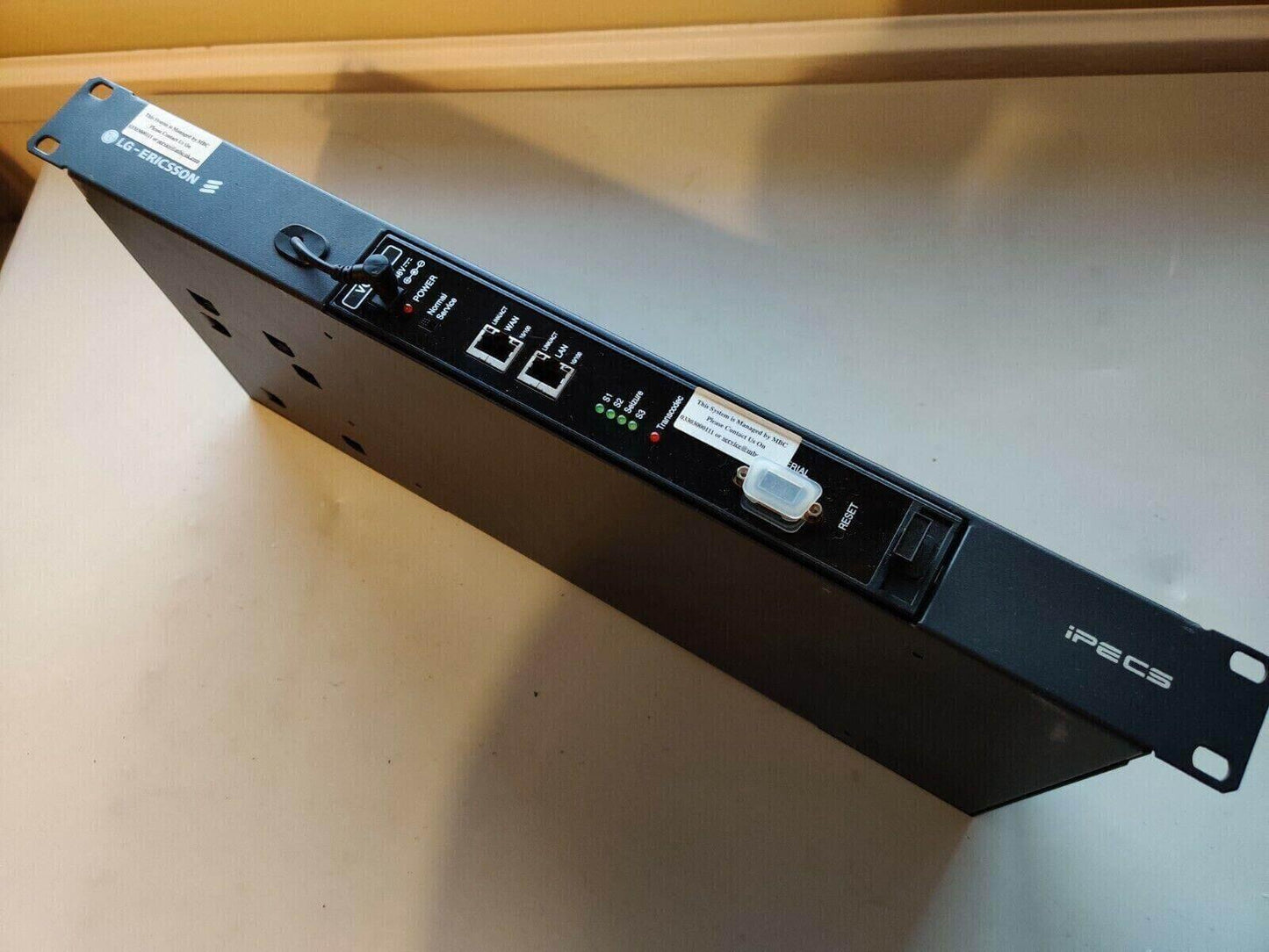 LG Ericsson iPECS LIK VOIM24 office phone system rack mount unit on tabletop