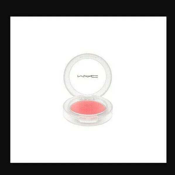 Pink powder blush in a clear round compact with open lid on white background