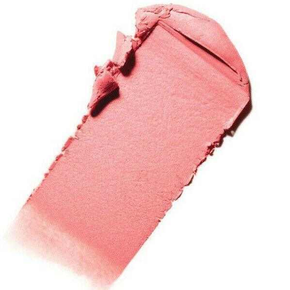 Crushed pink powder blush swatch on white background, makeup texture closeup