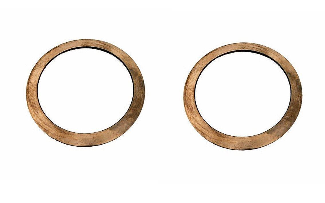 Pair of circular metal thrust washers for truck or tractor parts on white background
